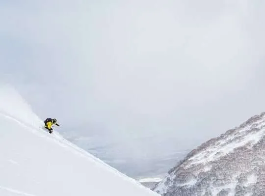 Skier skies in backcountry in Niseko, Hokkaido ski resort