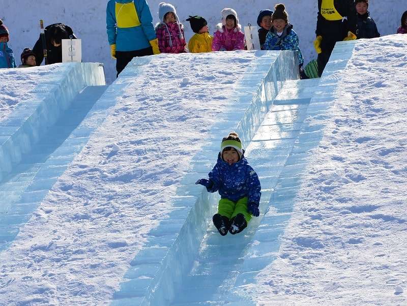 sapporo snow festival child on slide