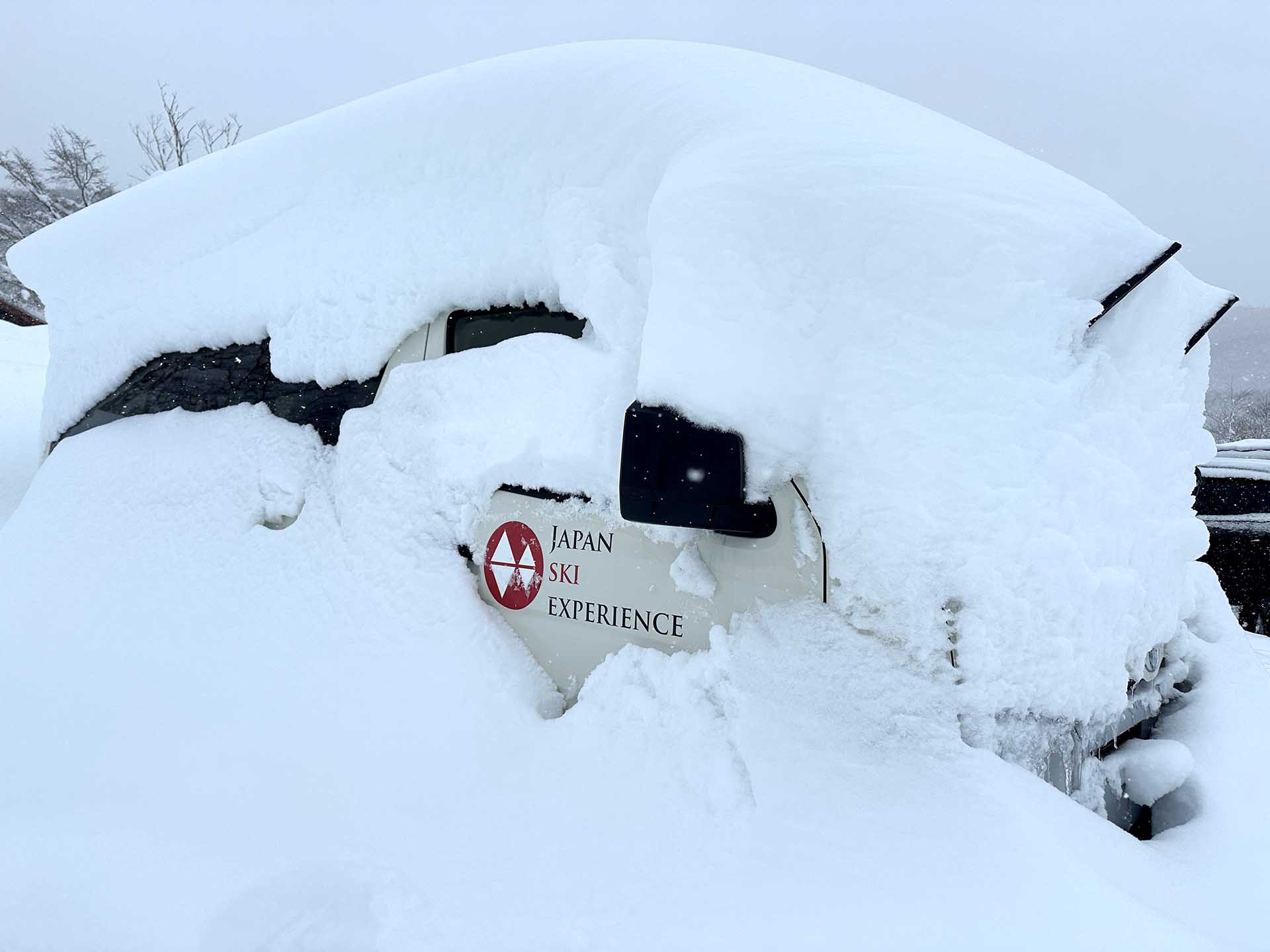 Japan Ski Experience van covered in snow in Japan