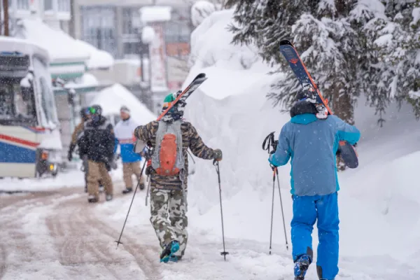 hakuba village skiers walking to the happo one gondola