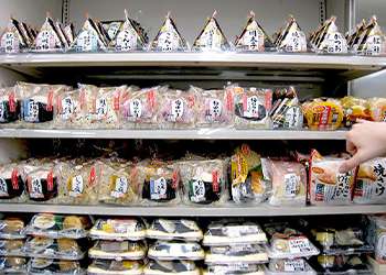 Supermarket shelves stocked with various Japanese snack foods.