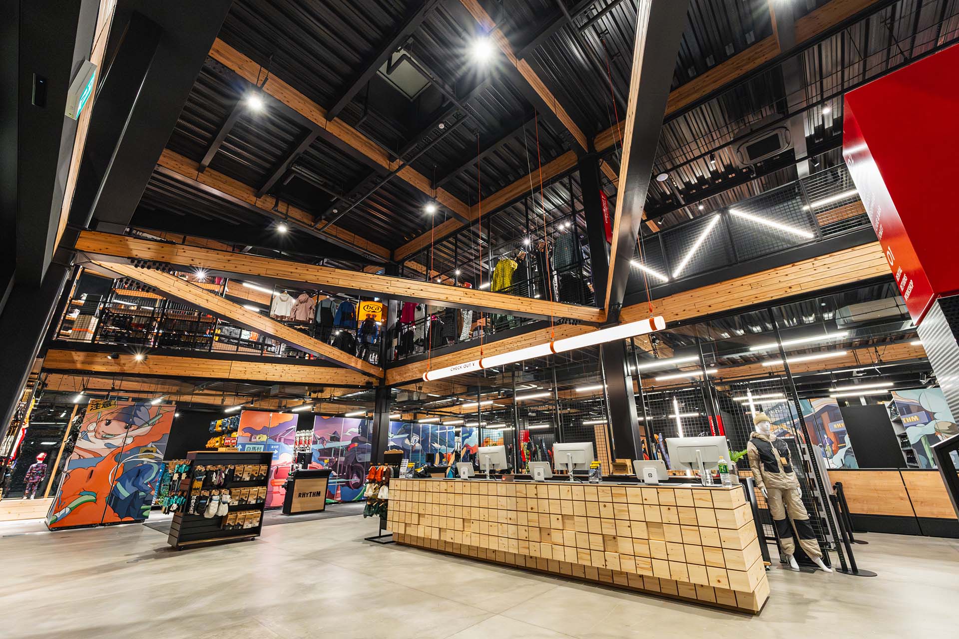 Modern interior of Rhythm Furano ski shop with wood beams, gear displays, and a large service counter.