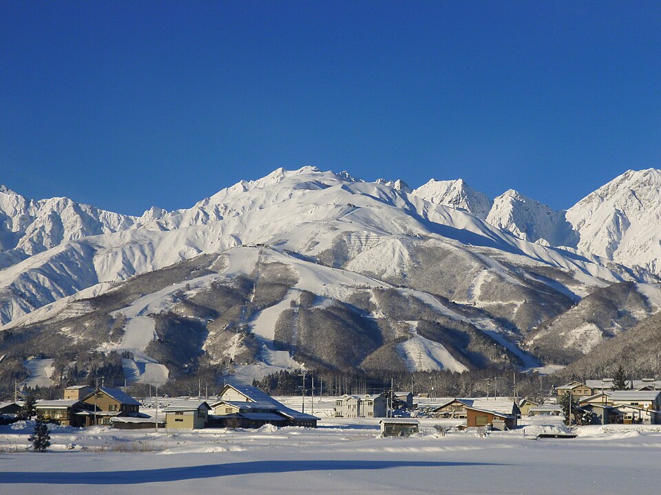 View of the Hakuba valley mountain ranges with a blue sky, with Happo One ski resort