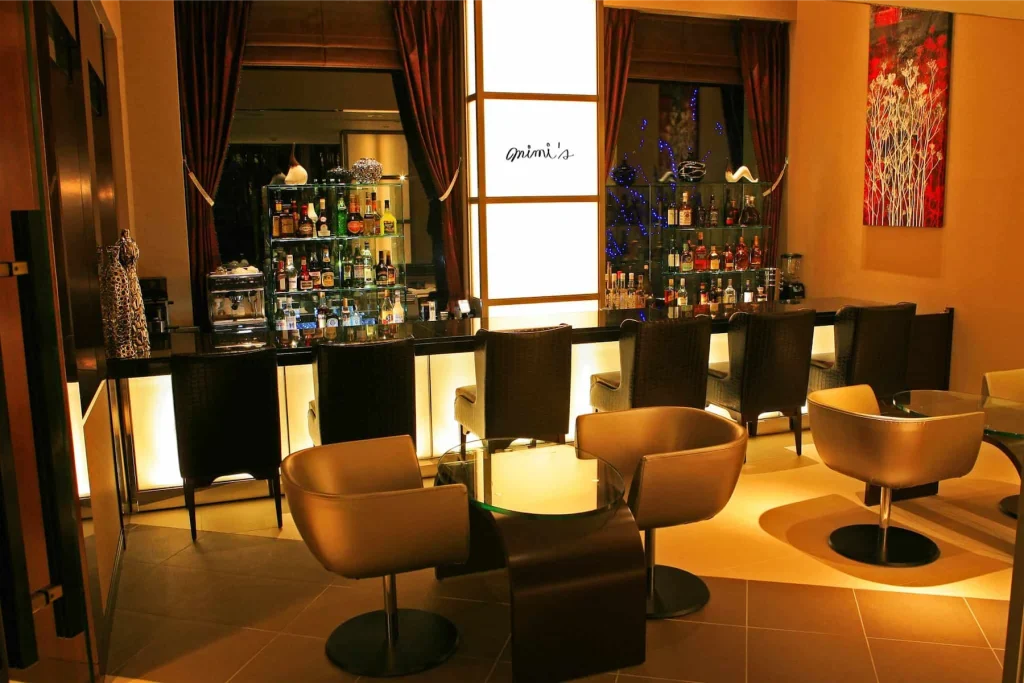 Elegant backlit bar counter and modern seating area at Mimi's inside Phoenix Hotel.