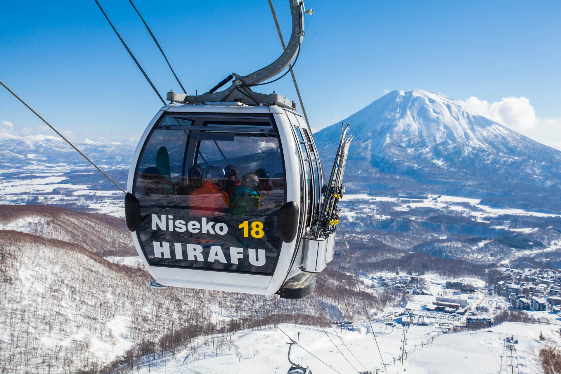 Niseko Hirafu gondola cabin carrying passengers with a panoramic view of Mount Yotei.